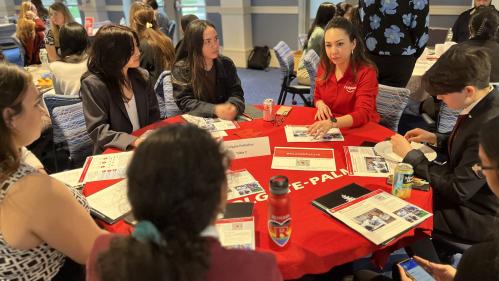 Students networking around a table