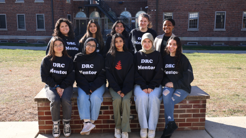 Douglass Students sit on quad in mentor shirts 