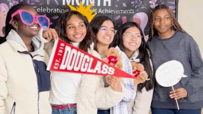 Students with a women's history month banner