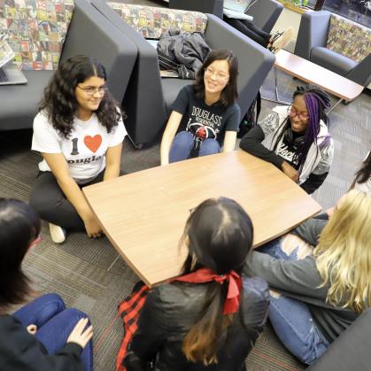 Students sit talking in LLC