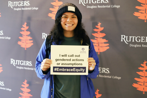 Students Holds Up an #EmbraceEquity Sign at Women's Day