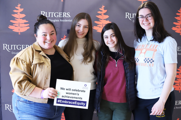 Students Holds Up an #EmbraceEquity Sign at Women's Day