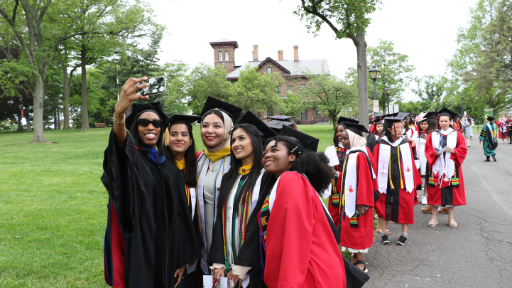 Douglass grads take a photo with Dr. Joseph