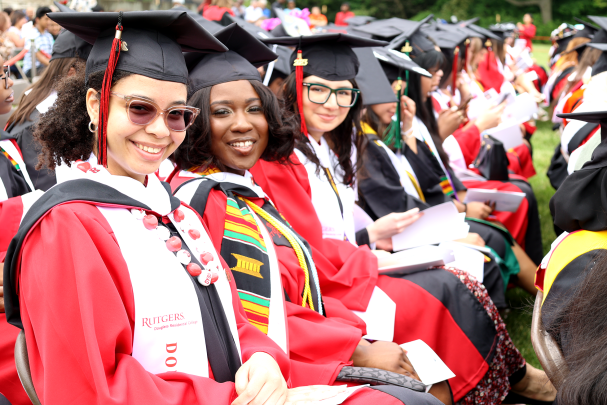 graduates sit on Antilles Field