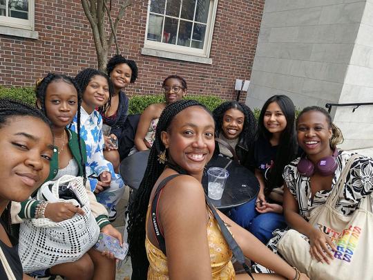 Group sits around table outside