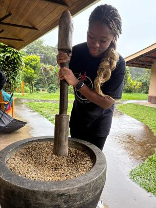 Student grinds/blends grain