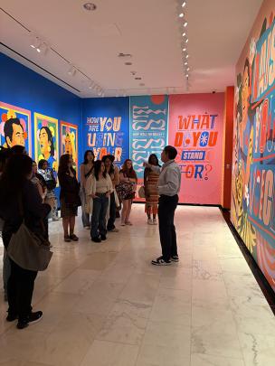 Students in museum listening to a guide