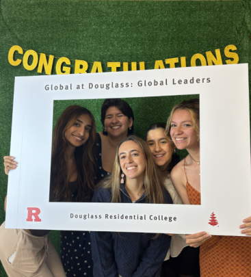 Students pose behind banner