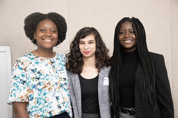 three students pose for photo