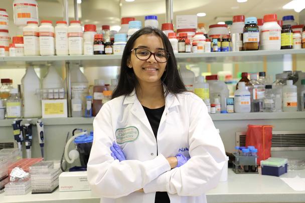 Student poses for photo in lab