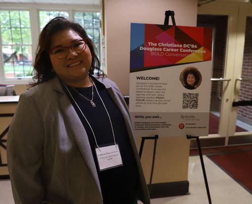 person stands in front of career conference sign