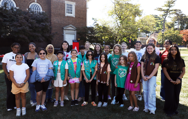 Students and children stand for photo