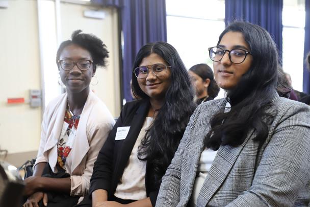 three students smile for photo